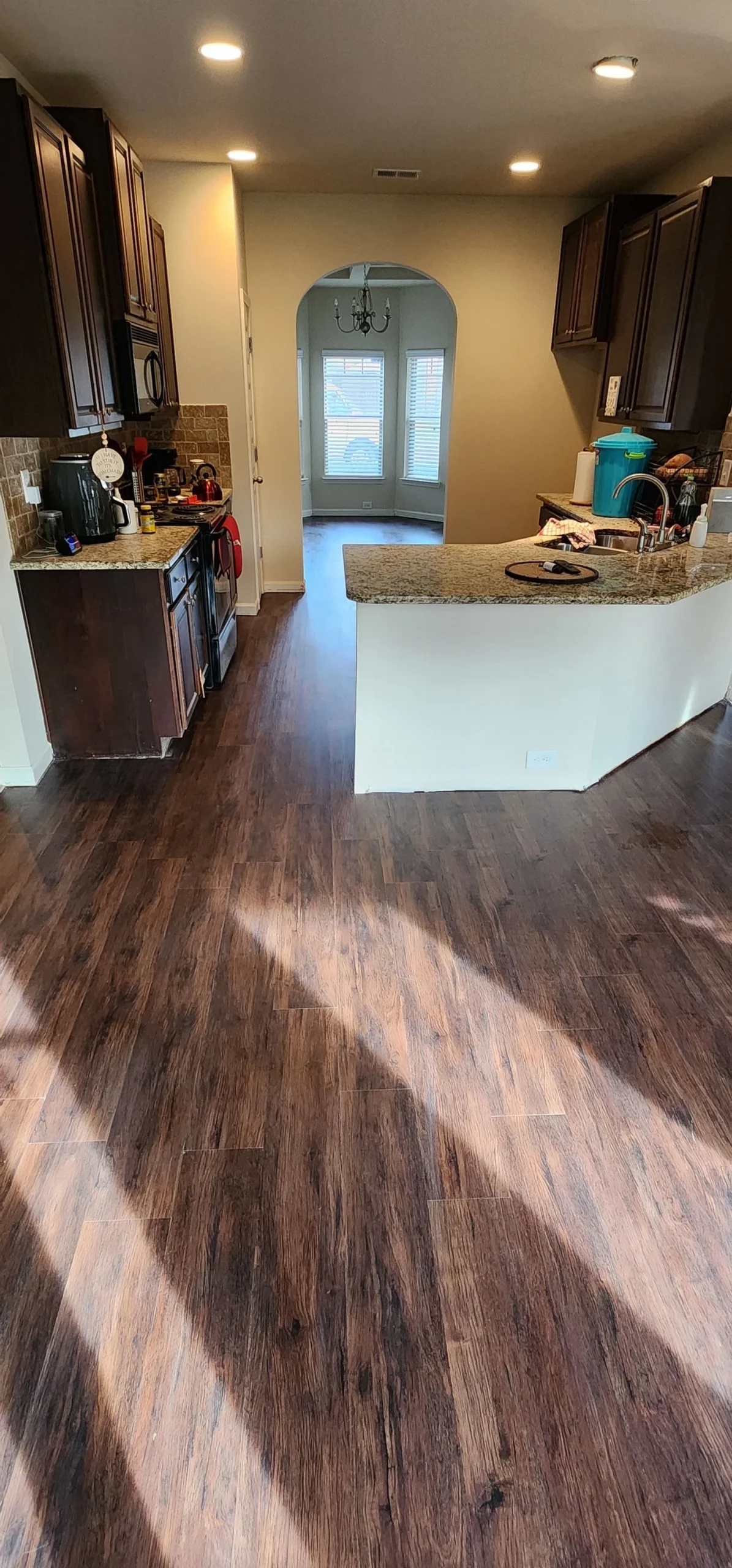 Dark hardwood flooring in a Metro Atlanta kitchen and hallway