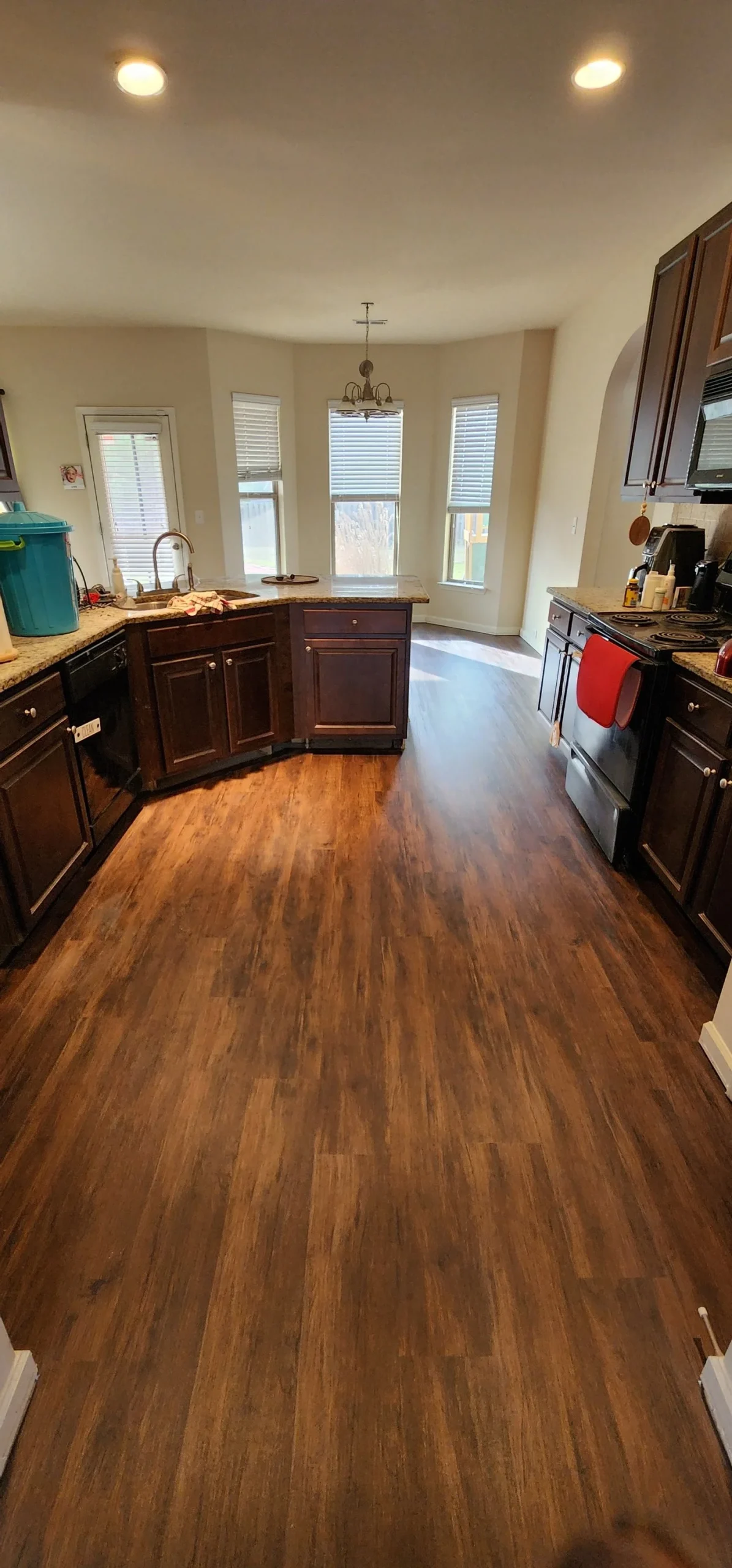 Rich hardwood flooring installed in a kitchen and dining area